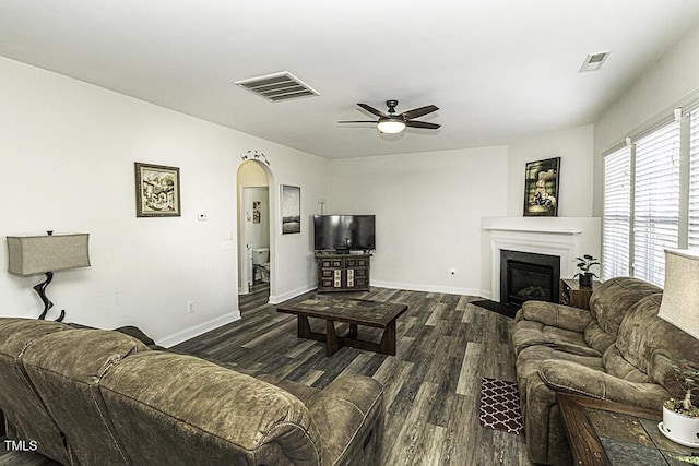 living room with ceiling fan and dark hardwood / wood-style floors