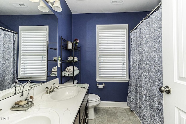 bathroom featuring vanity, toilet, and tile patterned flooring