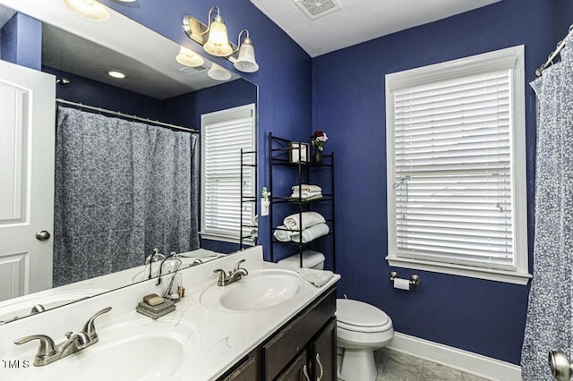 bathroom featuring tile patterned floors, toilet, and vanity