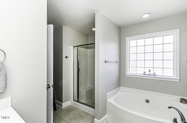 bathroom featuring vanity and plus walk in shower