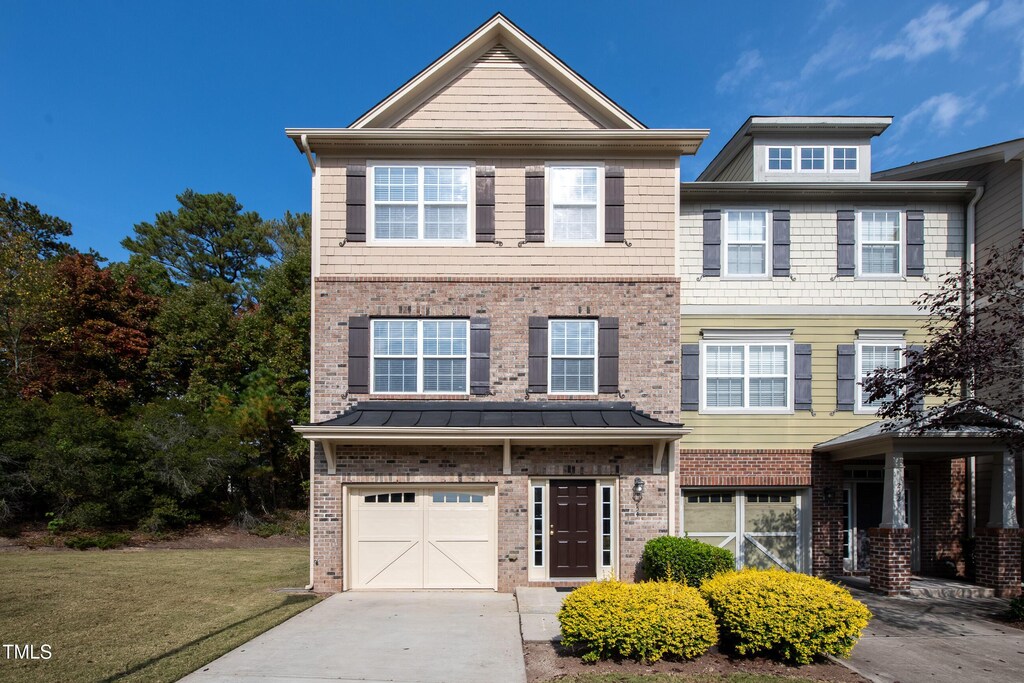 254 Linden Park Ln, Cary, NC 27519 - multi unit property featuring a garage, brick siding, concrete driveway, and a front lawn