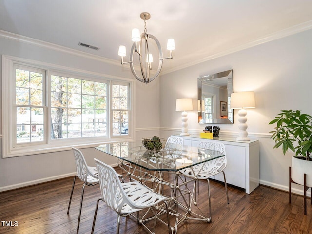 dining room with ornamental molding, dark wood-type flooring, and a chandelier