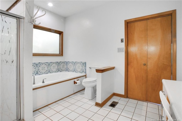 bathroom featuring tile patterned floors, toilet, and independent shower and bath