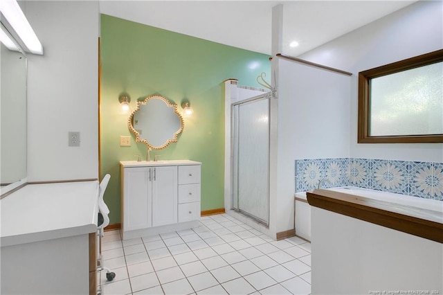 bathroom featuring a shower with door, vanity, and tile patterned floors