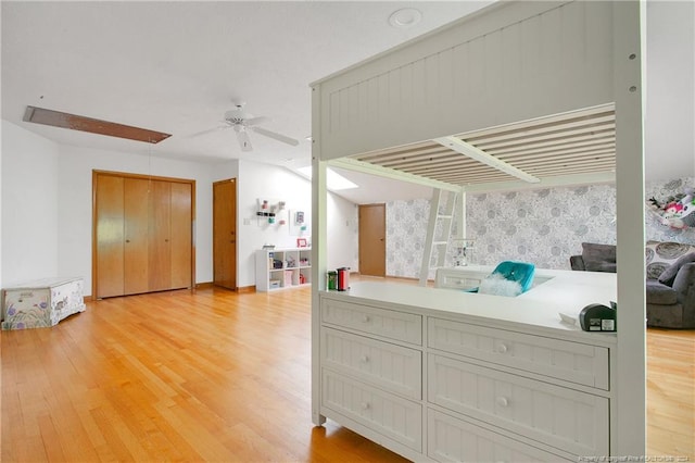 bedroom with ceiling fan and light hardwood / wood-style flooring