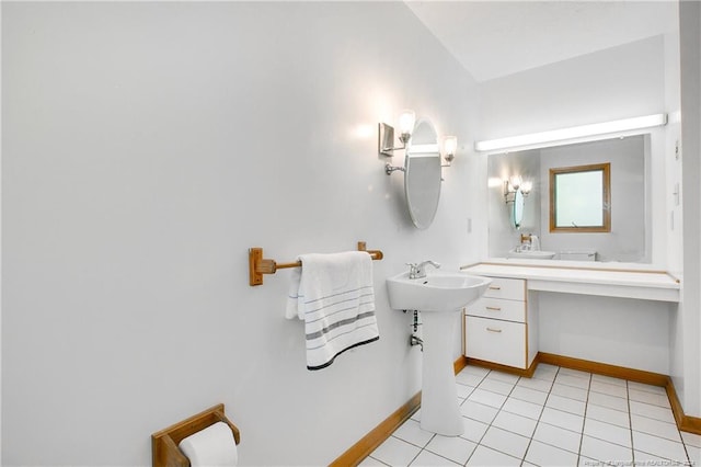 bathroom with dual sinks and tile patterned floors