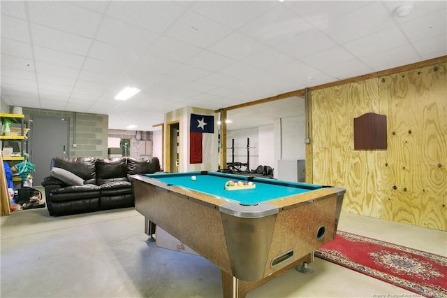 game room with wood walls, a paneled ceiling, and pool table