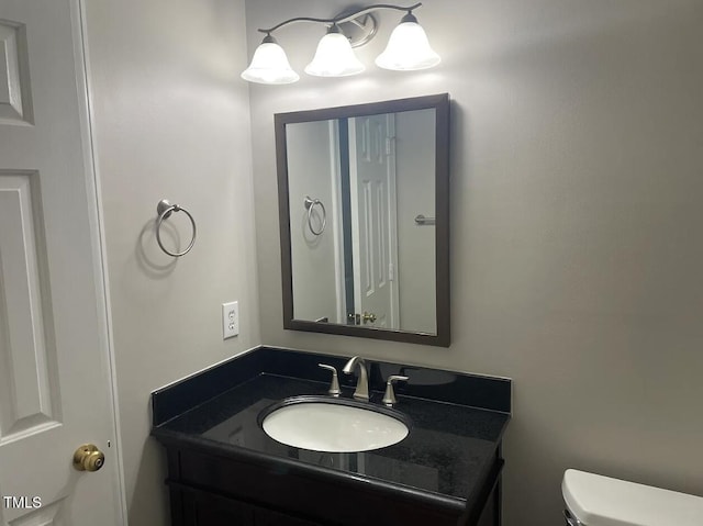 bathroom with toilet and vanity