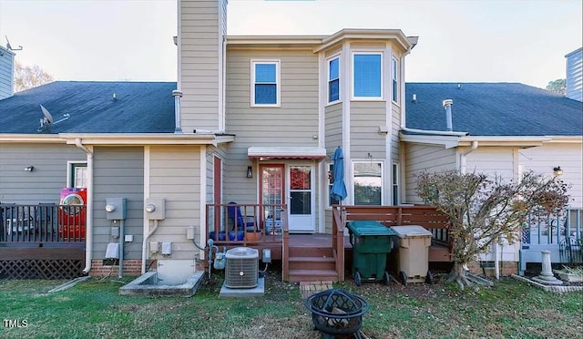 back of house featuring a lawn, central air condition unit, and a wooden deck