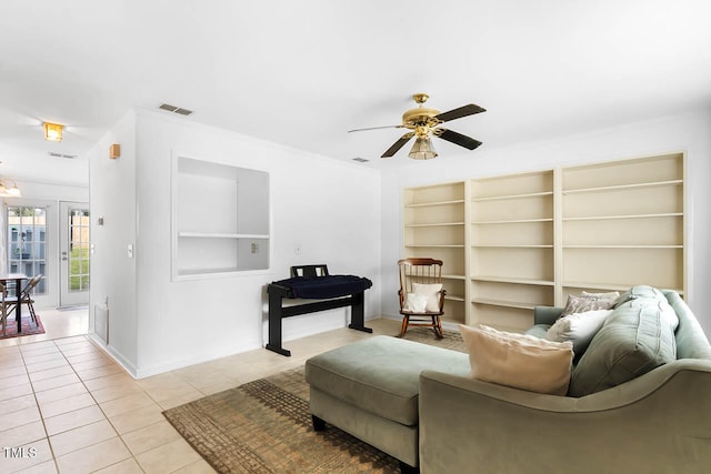 sitting room featuring light tile patterned floors and ceiling fan