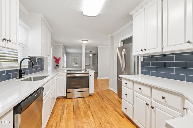 kitchen featuring white cabinetry, sink, light hardwood / wood-style flooring, and appliances with stainless steel finishes