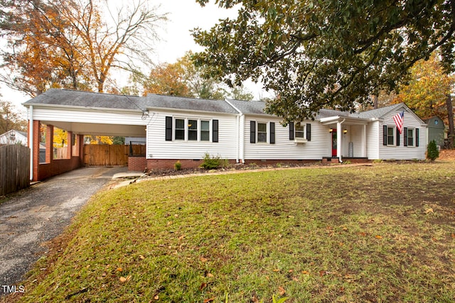 ranch-style home featuring a front lawn and a carport