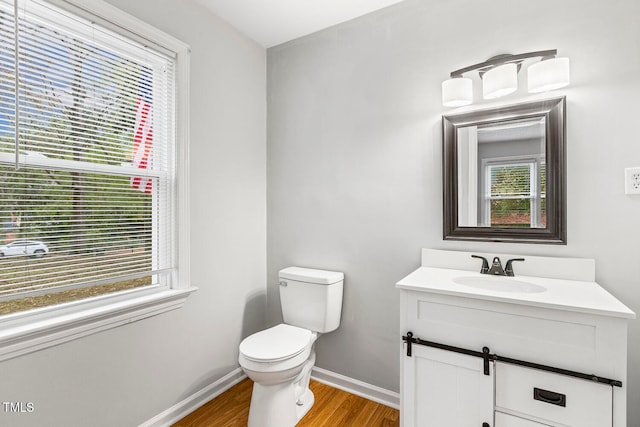 bathroom featuring hardwood / wood-style flooring, vanity, and toilet