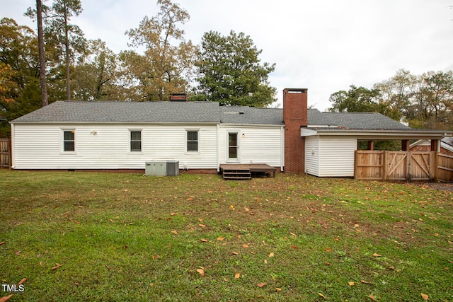 rear view of property featuring a lawn