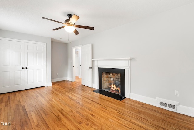 unfurnished living room with ceiling fan and light wood-type flooring