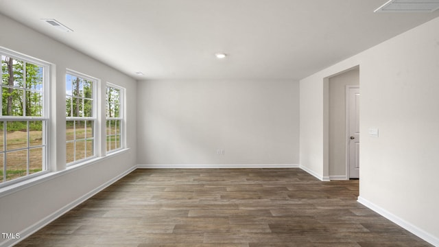 spare room with dark wood-type flooring