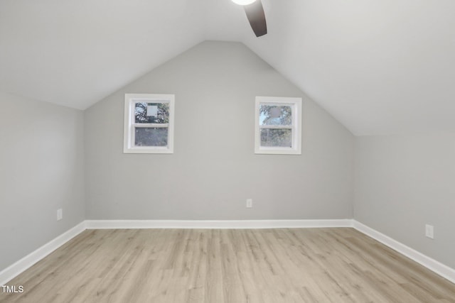 bonus room with ceiling fan, vaulted ceiling, a healthy amount of sunlight, and light hardwood / wood-style flooring