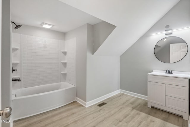 bathroom with bathtub / shower combination, vanity, and wood-type flooring