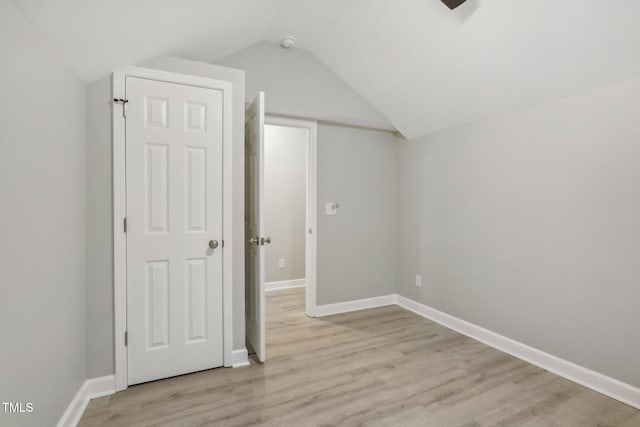 bonus room featuring light wood-type flooring and lofted ceiling