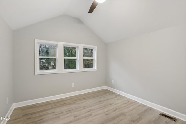 unfurnished room with light hardwood / wood-style floors, ceiling fan, and vaulted ceiling