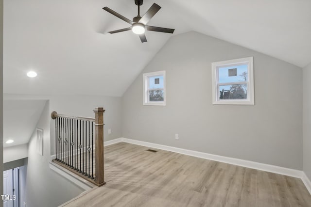 additional living space featuring light wood-type flooring, lofted ceiling, and ceiling fan