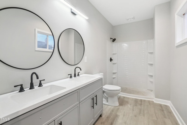 bathroom with walk in shower, toilet, hardwood / wood-style flooring, and plenty of natural light