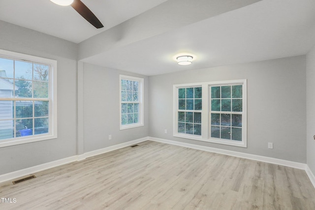 empty room with ceiling fan and light wood-type flooring