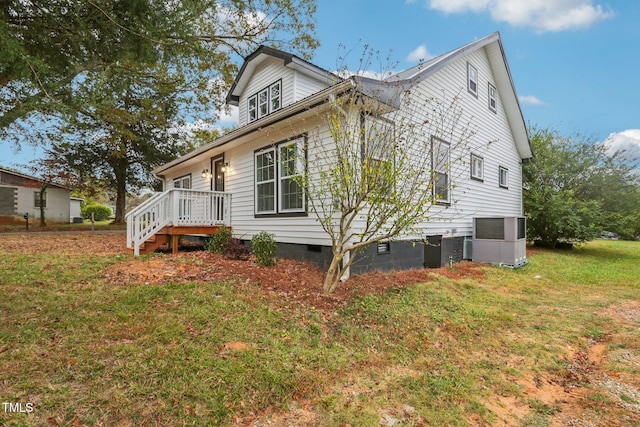 rear view of house with a yard and a deck