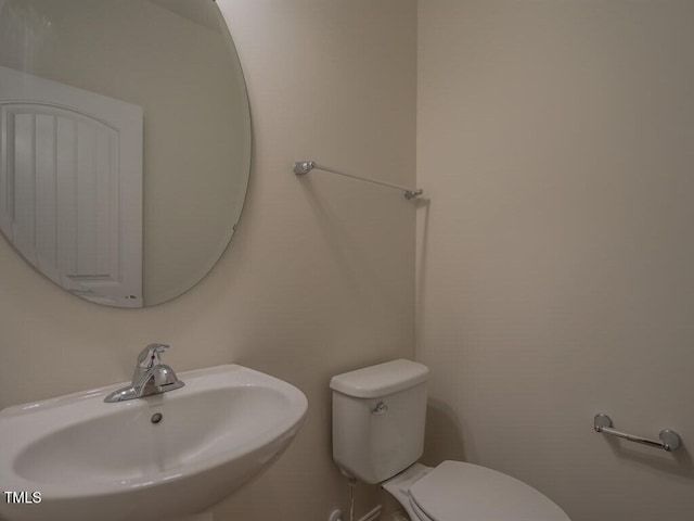 bathroom featuring toilet and sink