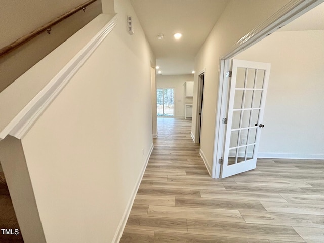 corridor with light wood-type flooring