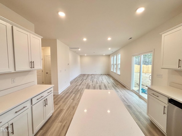 kitchen featuring dishwasher, light hardwood / wood-style floors, and white cabinetry