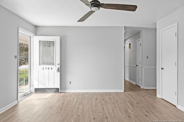 spare room with ceiling fan and light hardwood / wood-style flooring