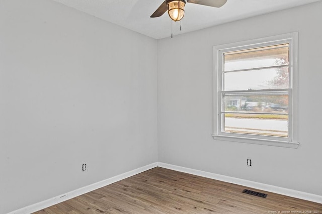 unfurnished room with hardwood / wood-style flooring and ceiling fan