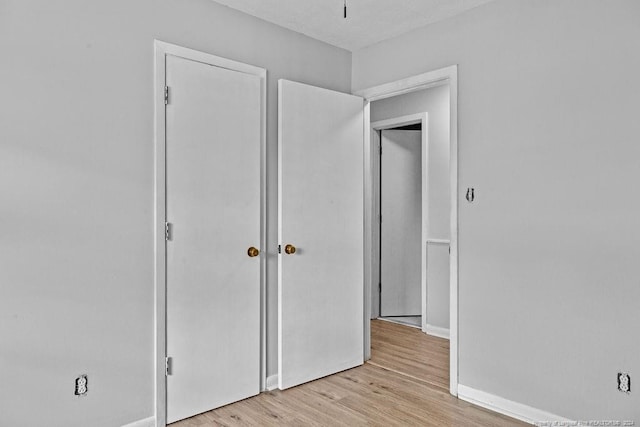 unfurnished bedroom with light wood-type flooring