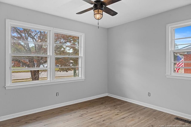 spare room with hardwood / wood-style flooring and ceiling fan