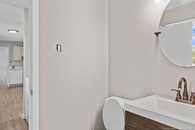 bathroom featuring hardwood / wood-style floors, vanity, and toilet