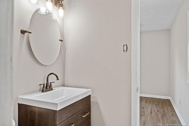 bathroom with hardwood / wood-style flooring and vanity