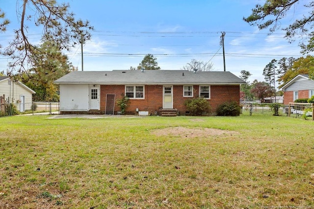 back of house with a lawn