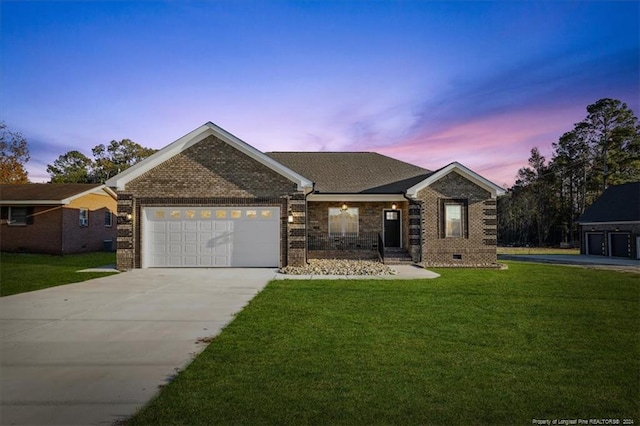 view of front of house featuring a garage and a lawn