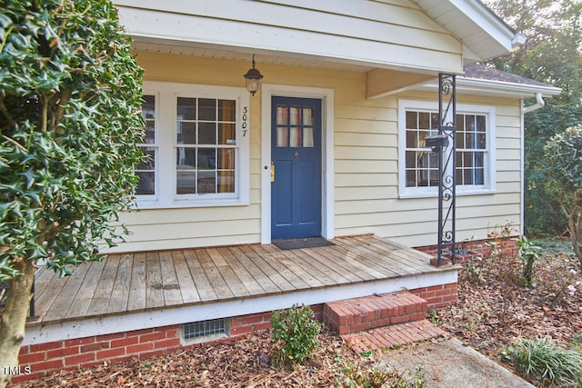 view of exterior entry with a deck