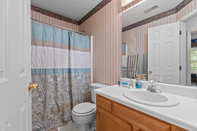 bathroom with vanity, a shower with curtain, a textured ceiling, and toilet