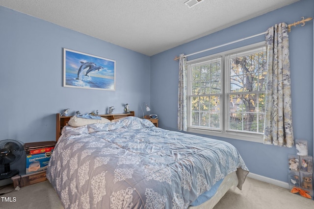 carpeted bedroom featuring a textured ceiling