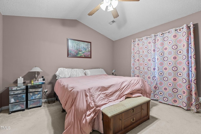 bedroom with a textured ceiling, ceiling fan, light carpet, and vaulted ceiling