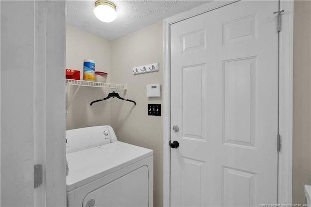 laundry room featuring washer / dryer and a textured ceiling