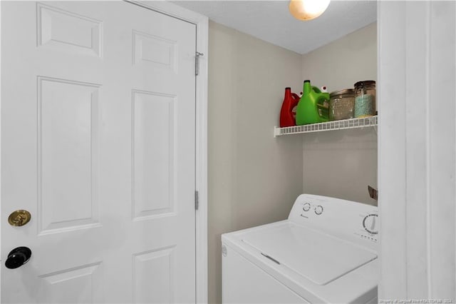 washroom featuring a textured ceiling and washer / dryer