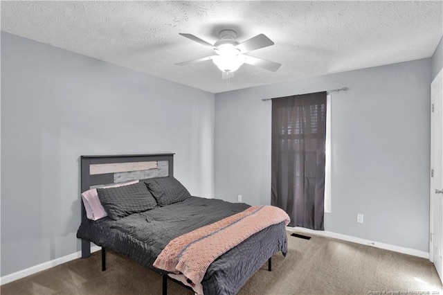 bedroom with carpet, a textured ceiling, and ceiling fan