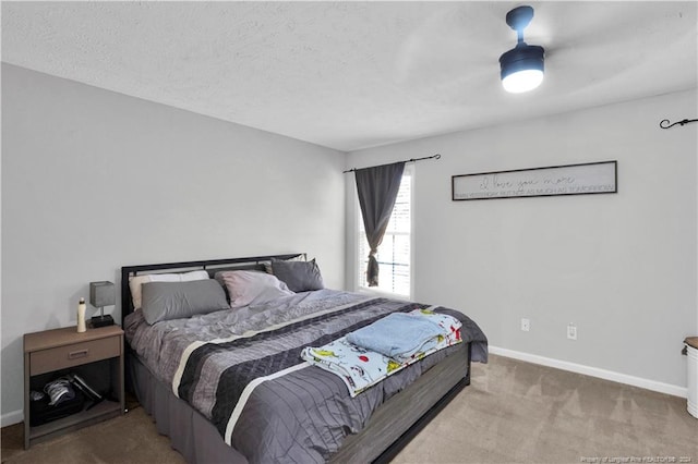 bedroom with carpet flooring and a textured ceiling