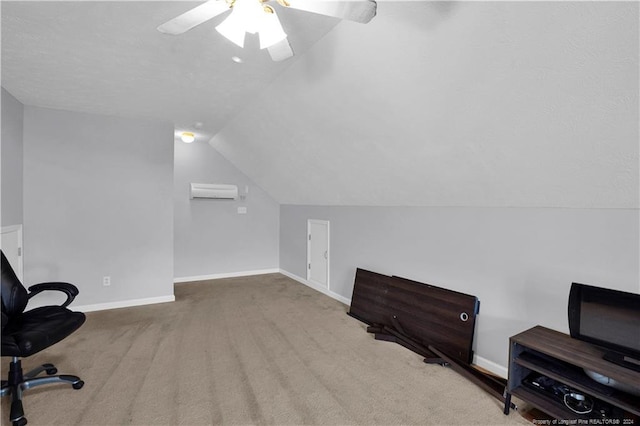 carpeted home office featuring vaulted ceiling, a wall mounted air conditioner, and ceiling fan