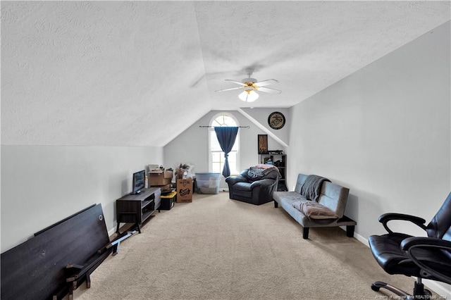 living area featuring lofted ceiling, a textured ceiling, ceiling fan, and carpet floors