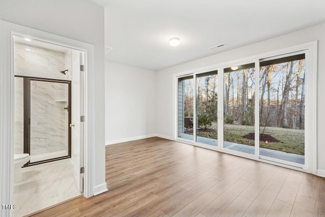 unfurnished room with light hardwood / wood-style floors